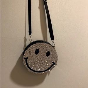 Circular smiley face crossbody
